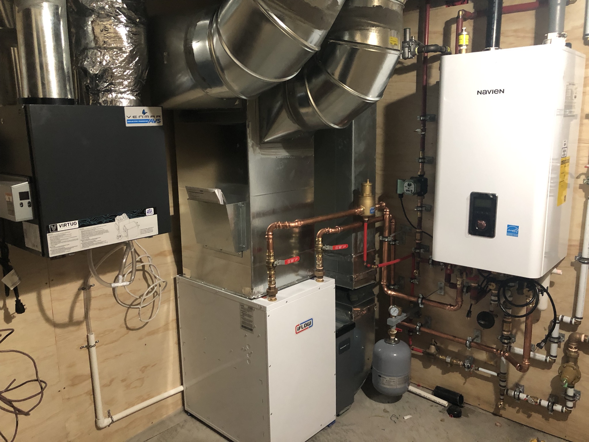 High-performance mechanical room with HRV, air handler and tankless water heater